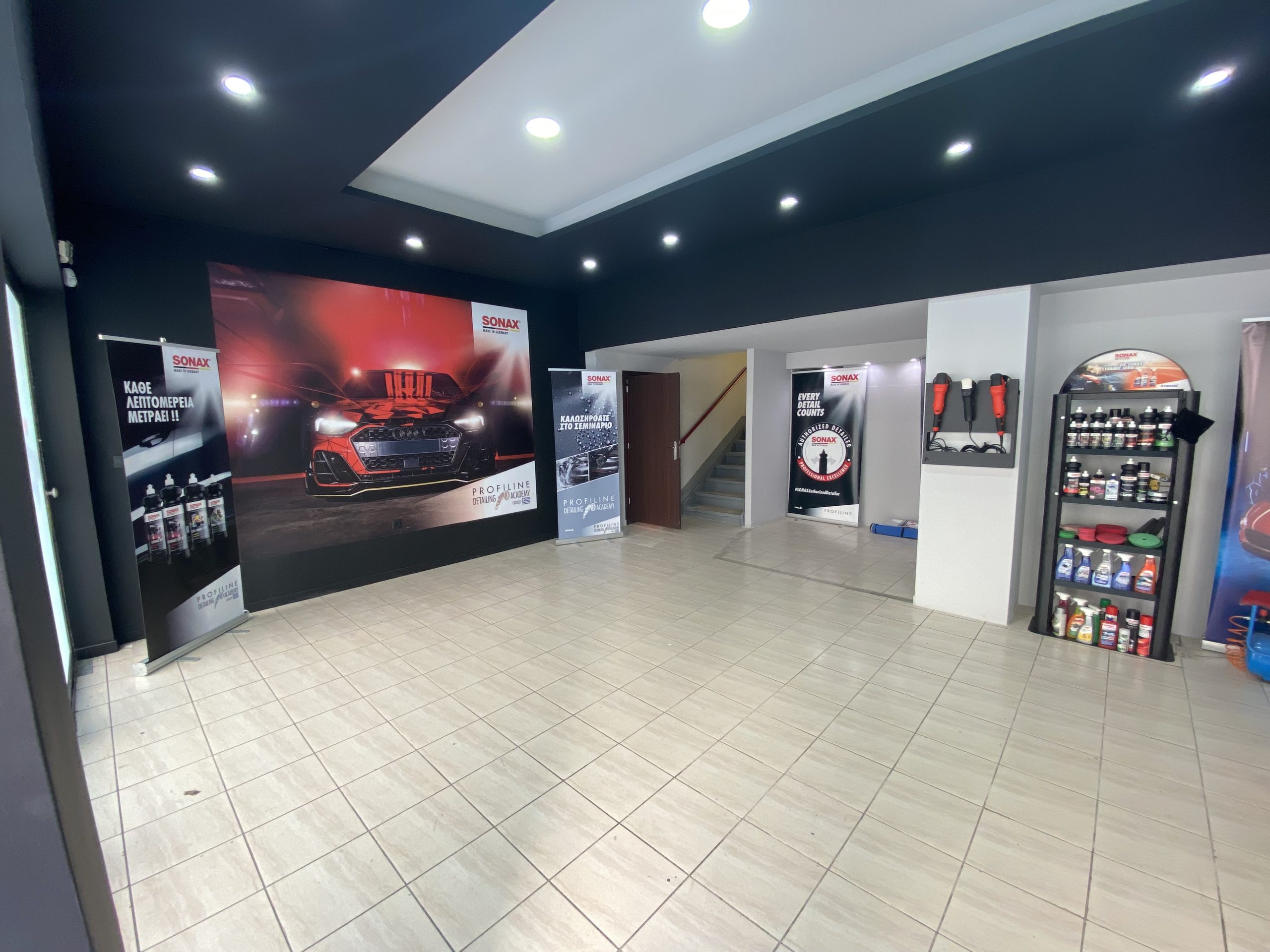 A detailer prepares a black Porsche.