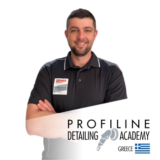 A detailer prepares a black Porsche.